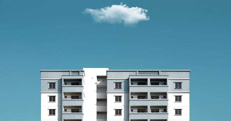 Top level of a condominium tower agains a clear blue sky.