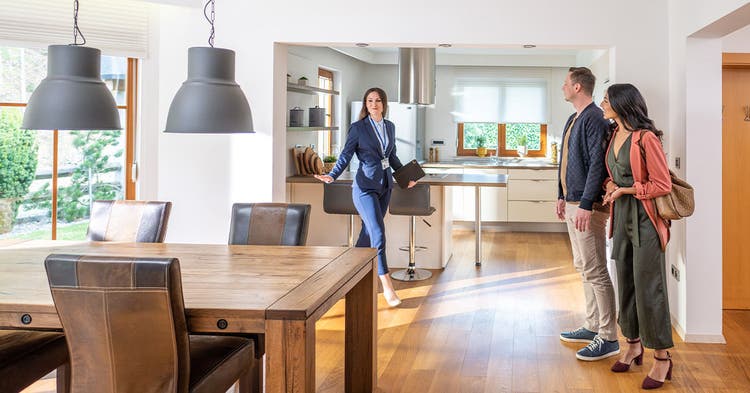 Female real estate agent showing couple a home